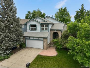 Charming two-story home with a well-manicured lawn and a two car garage at 1190 W 11Th Ct, Broomfield, CO 80020