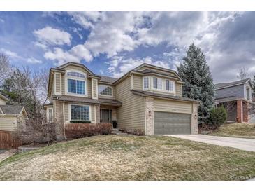 Charming two-story home with a well-maintained lawn and attached two-car garage at 7114 Mountain Brush Cir, Highlands Ranch, CO 80130
