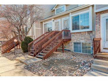 Townhouse exterior with stairs and stone accents at 1885 S Quebec Way # L102, Denver, CO 80231
