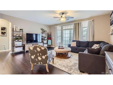 Cozy living room featuring hardwood floors, an area rug, modern decor, and lots of natural light at 1560 Olympia Cir # 108, Castle Rock, CO 80104