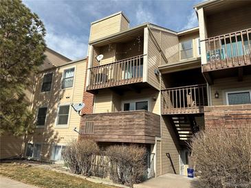 Tan two-story condo building with balconies and stairs at 15350 E Arizona Ave # 308, Aurora, CO 80017