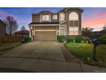 Charming two-story home with a well-manicured lawn, mature landscaping, and a spacious driveway at 10732 Cook Ct, Northglenn, CO 80233