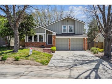 Charming two-story home with a two-car garage and well-maintained front lawn at 7942 S Vincennes Way, Centennial, CO 80112