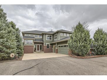 Beautiful two-story home featuring an attached two-car garage and manicured landscaping at 11020 E 150Th Pl, Brighton, CO 80602