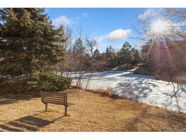 Peaceful pond view with a bench, perfect for relaxing at 1150 Golden Cir # 201, Golden, CO 80401