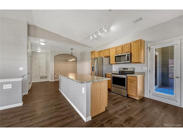 Modern kitchen with stainless steel appliances and wood cabinets at 9451 Ashbury Cir # 202, Parker, CO 80134