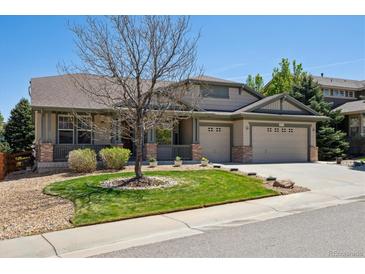 Charming home with a well-manicured lawn and a three-car garage, perfect for a growing Gathering at 8068 Dressage Rd, Littleton, CO 80125