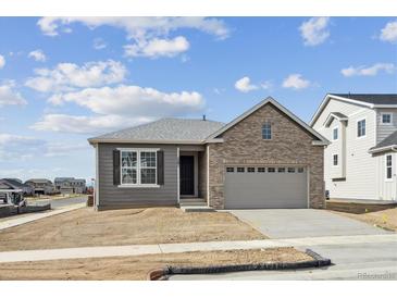 Charming single-Gathering home features a brick facade, gray siding, and attached two-car garage at 1281 Rock Cliff Ave, Erie, CO 80516