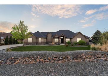 Charming single-story home featuring stone accents, manicured lawn, and lovely landscaping at 12939 Wabash Ct, Thornton, CO 80602