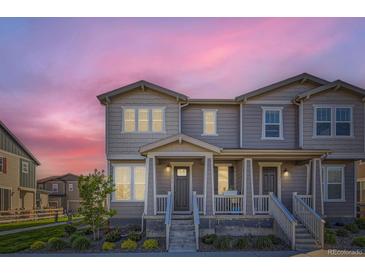 Charming two-story townhome with a covered front porch and beautiful landscaping at 2419 Flats St, Erie, CO 80516