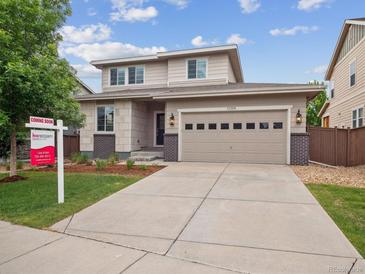 Charming two-story home boasts a well-manicured lawn, neutral siding, and an attached two-car garage at 15350 W 50Th Dr, Golden, CO 80403