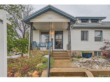 Charming home featuring a covered front porch with seating and stone accents at 4001 Kalamath St, Denver, CO 80211