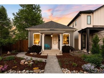 Charming home with a well-manicured front yard and inviting walkway, perfect curb appeal at 3842 Zenobia St, Denver, CO 80212