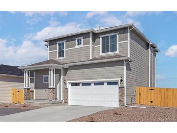 Charming two-story home featuring a neutral color palette, attached two car garage, and a covered front porch at 9484 Yampa St, Commerce City, CO 80022