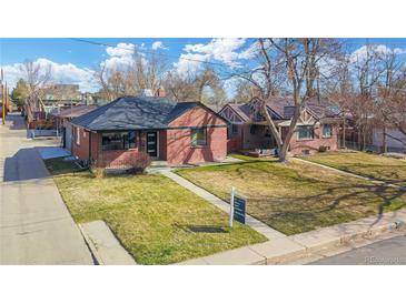 Charming brick home featuring a well-manicured lawn and inviting curb appeal at 2731 W 42Nd Ave, Denver, CO 80211