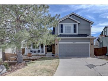 Charming two-story home with a well-manicured lawn and an attached two-car garage at 2888 Deer Creek Trl, Highlands Ranch, CO 80129