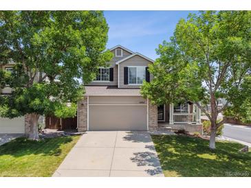 Charming two-story home with a well-manicured front yard and attached two-car garage at 4997 Collinsville Pl, Highlands Ranch, CO 80130