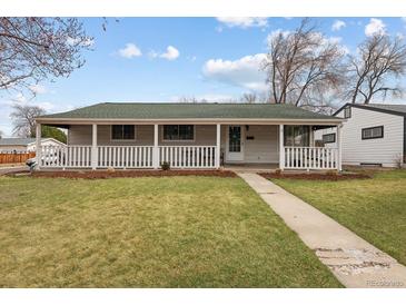 Charming single-story home featuring a spacious front yard with a welcoming, covered porch at 3244 S Holly St, Denver, CO 80222