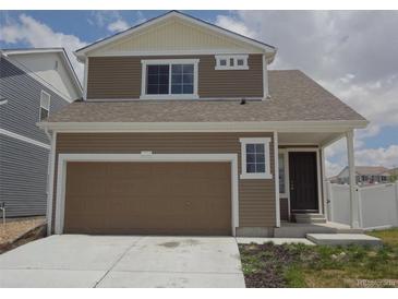 Two-story home with attached garage and landscaped front yard at 5550 Malta St, Denver, CO 80249