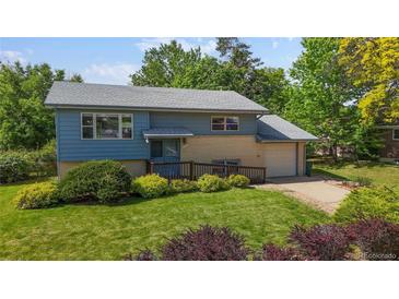Charming two-story home with blue siding, brick accents, and a well-manicured lawn at 11718 Keough Dr, Northglenn, CO 80233