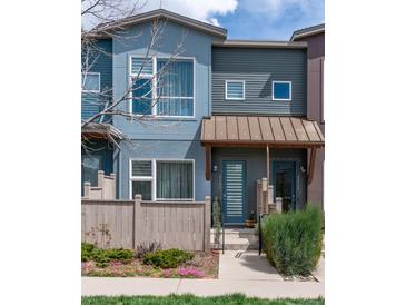 Charming townhouse with colorful exterior, covered entryway, and landscaped front yard with a picket fence at 4150 Longview Ln, Boulder, CO 80301