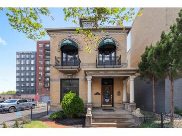 Stunning two-story home with charming balconies, decorative facade, and manicured front yard at 1650 N Pennsylvania St, Denver, CO 80203