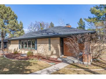 Brick ranch-style home featuring mature landscaping and a charming front entryway at 374 Holly St, Denver, CO 80220