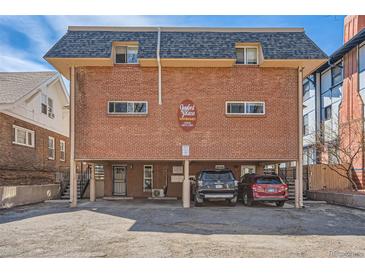 Brick building exterior with parking and a spacious yard at 1355 Gaylord St # 10, Denver, CO 80206