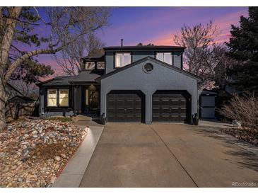 Beautiful two-story home featuring a two-car garage and a well-maintained front yard at sunset at 14707 E Wagon Trail Dr, Aurora, CO 80015
