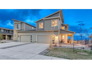 Two story home featuring a two car garage, stone porch accents and low maintenance front yard at 1734 Peak Prairie Ln, Monument, CO 80132