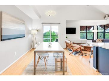 Bright living room with modern furnishings, dining area, and balcony access at 3069 Tejon St # B, Denver, CO 80211