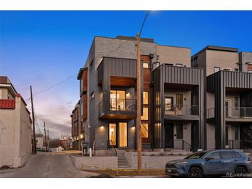 Contemporary townhome featuring brick and metal accents, recessed balconies, and a welcoming entrance at 2330 Eliot St # 1, Denver, CO 80211