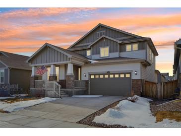 Two-story house with gray siding, stone accents, and a two-car garage at 17693 Elati St, Broomfield, CO 80023