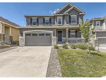 Beautiful two-story home featuring a well-manicured lawn and a two-car garage at 10863 Endeavor Dr, Parker, CO 80134