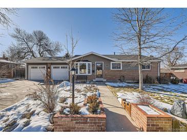 Ranch home with brick facade, attached garage, and landscaped front yard at 6995 S Ash Cir, Centennial, CO 80122