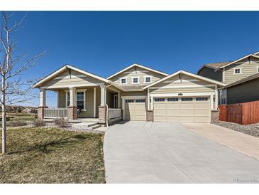 Charming tan home with a large driveway and three-car garage, great curb appeal at 14521 Vancouver Pl, Parker, CO 80134
