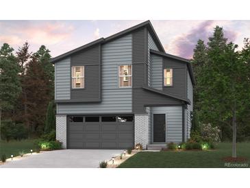 Modern two-story home with gray siding, white brick accents, and a two-car garage at 19019 E 94Th Pl, Commerce City, CO 80022