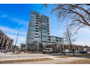 Modern high-rise building with glass exterior, blue sky, and street view at 4200 W 17Th Ave # 327, Denver, CO 80204