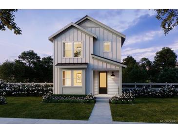 Charming two-story home with a black front door, white picket fence and beautiful landscaping at 8779 Whiteclover St, Littleton, CO 80125