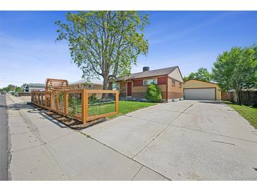 Charming brick home featuring a spacious driveway and well-maintained landscaping at 7820 Tejon St, Denver, CO 80221