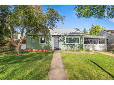 Charming single-story home features a well-manicured lawn, mature trees, and inviting walkway to the front door at 7550 Stuart St, Westminster, CO 80030