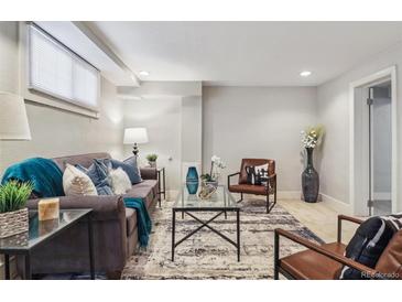 Finished basement with modern furniture, neutral colors, and ample seating at 3527 W 44Th Ave, Denver, CO 80211