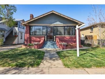 Charming brick bungalow with a landscaped front yard and inviting entryway stairs at 3527 W 44Th Ave, Denver, CO 80211