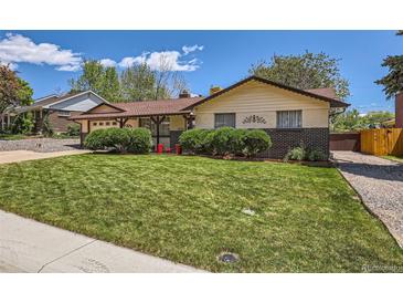 Charming ranch-style home featuring a well-maintained lawn and inviting curb appeal at 6436 Otis St, Arvada, CO 80003