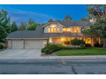 Charming two-story home boasting a three-car garage and beautiful landscaping, perfect for suburban living at 5063 E Otero Cir, Centennial, CO 80122