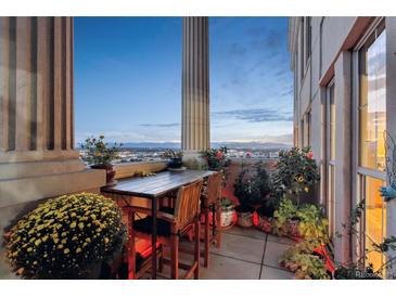 Spacious balcony with city views, seating, and potted plants at 300 W 11Th Ave # 18C, Denver, CO 80204