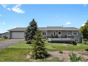 Charming single-story home with a spacious front yard and a lovely wood deck at 3596 Longs Peak Cir, Parker, CO 80138