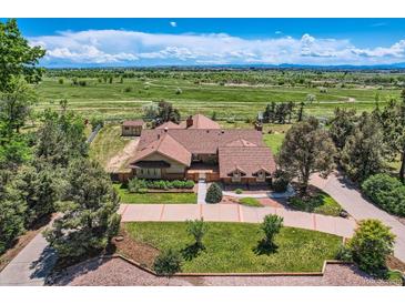 Expansive aerial view of a sprawling home with lush greenery and scenic landscape, perfect for luxurious living at 14030 E Progress Way, Aurora, CO 80015