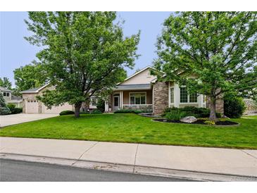 Charming single-Gathering home featuring a well-manicured lawn and mature trees enhancing curb appeal at 3144 Stevens N Cir, Erie, CO 80516