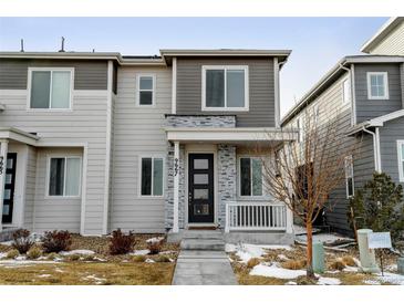 Charming two-story home with modern siding and a welcoming front porch at 9667 Walden St, Commerce City, CO 80022